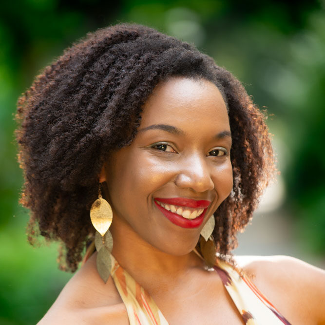 Image of Onome in front of blurred greenery of trees